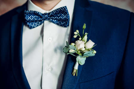 stylish boutonniere on the grooms jacket, wedding day, beautiful flower boutonniere, wedding conceptの写真素材