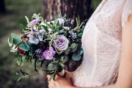 Wedding bouquet of the bride in womens hands. wedding flowers. Bridal bouquet of fresh flowers, wedding conceptの写真素材