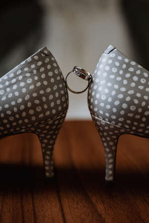 wedding ring sandwiched between wedding shoes, wedding day, bride's ring, close-upの写真素材