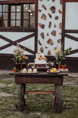 kendybar on the table is a cake muffins cupcakes, sweet treats for children, catering design in boho style, wedding table design, rustic style with macrame elementsの写真素材