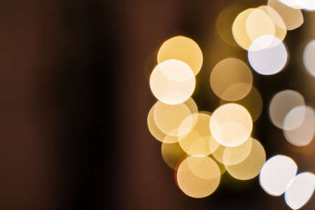 small lights garlands hanging on a white wall, taken in the evening, close-up, macro photography