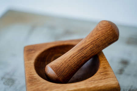 A close shot of a brown wooden mortar with a pestle. High quality photoの写真素材