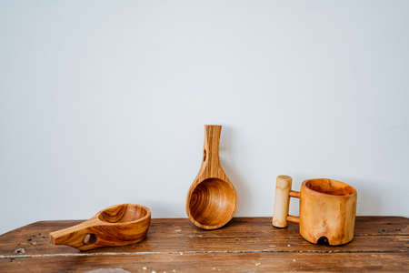 Horizontal frame of homemade wooden plates and mugs on a light background. High quality photoの写真素材