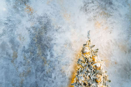 The Christmas tree in Christmas decorations stands on a minimalist background. Christmas and New Year's mood. Decorations for the holiday. High quality photoの写真素材