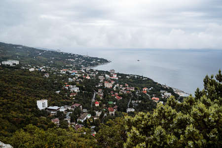 Panoramic view of the city by the sea from above. Seaside coast with villas. Summer day by the sea....