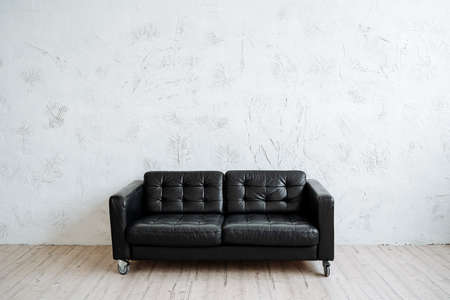 Perfect black leather sofa in a minimalist style. Modern furniture, convenience and comfort. High...