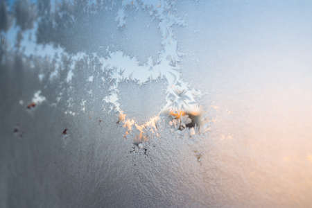 The texture of the glass covered with frost in winter in cold. Magical winter patterns on the glass....
