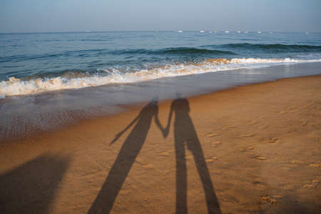 a couple on the beach with sunset. Walk along the seashore. outdoor recreationの写真素材
