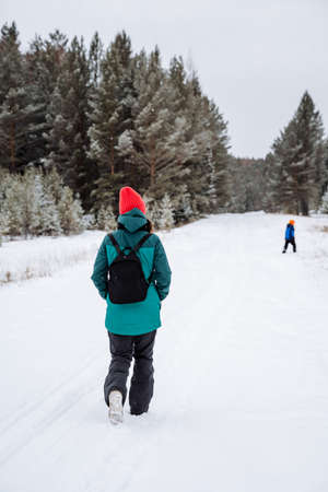 girl walking in the winter forest. Survival in the wild. Snow-covered forests. Walking in the winter...