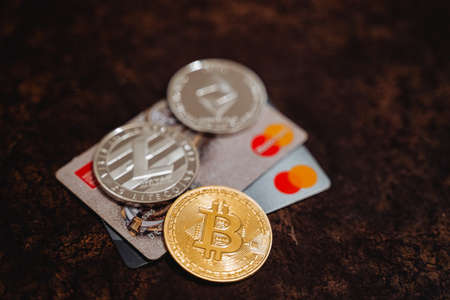 Ufa, Russia - January 12, 2022: Cryptocurrency together with plastic cards. Bitcoin and MasterCard. Digital currency. High quality photoのeditorial素材