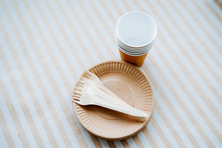 A set of paper dishes. Eco materials for cutlery. Glasses, forks, plates. Recyclable raw materials. high quality photoの写真素材