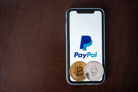 Russia Ufa February 2022: Paypal accepts bitcoin payment. Cryptocurrency in the phone. Electronic money together with blockchain technology. high quality photoのeditorial素材