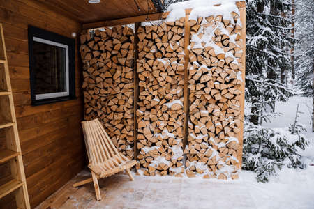 Garden chaise longue made of wood. Garden chair for outdoor seating, Logs. Chopped birch firewood in a log. stacked firewood in the backyard. high quality photoの写真素材