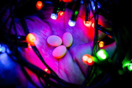 Happy New Year background for greeting card. snowman candlestick close-up with festive garland....