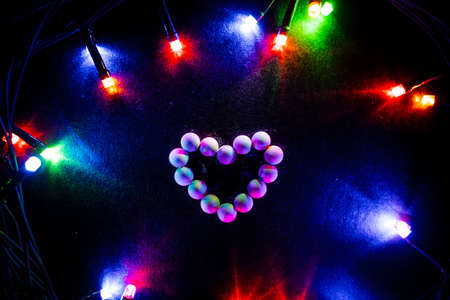 The heart is lined with white candy. Figurines of sweets. Abstract photos against a background of...