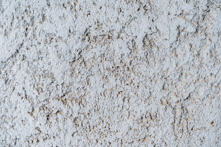 textured wall. Peeling plaster on the white wall. Aged wall covering. textured surface in the surrounding environment. Renovation required. high quality photoの写真素材