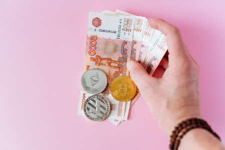 In the hands of a large amount of paper money and bitcoin coins. Wealth, Russian Currency and World Bitcoin, ,How to Invest. high quality photoの写真素材