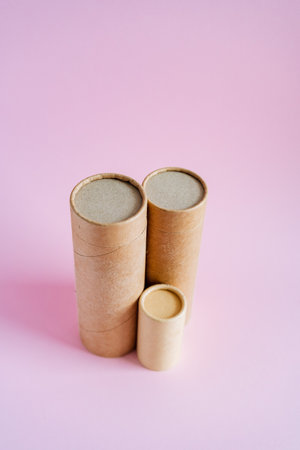 Craft tubes of different sizes stand on a pink background. Cardboard boxes for pencils. packing set. subject survey of packaging goods. high quality photoの写真素材
