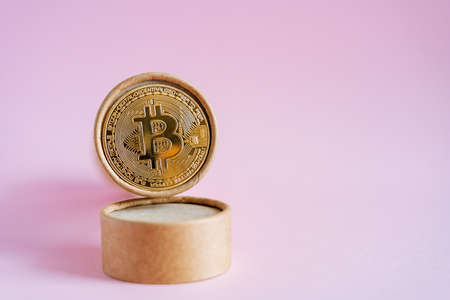 Bitcoin coin in a cardboard case. Requires a powerful computer system to earn bitcoin.new money of the modern world. How to invest, earn and spend money. high quality photoの写真素材