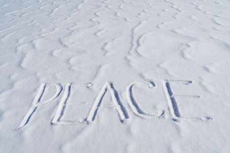 The word peace is written in the snow. Letters calling for the unification of countries around the world. The concept of peaceful coexistence of the population. Text to write in the snowの写真素材