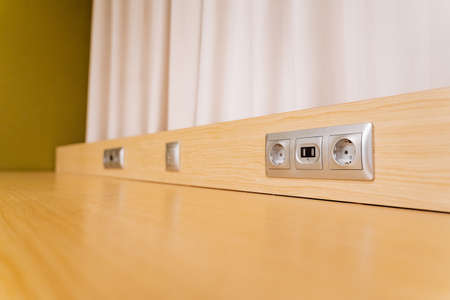 A socket for household appliances is built into the base of the table, a gray socket, a slot for...