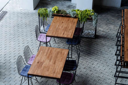 Street cafe on the sidewalk there are empty tables, there are no people, the designer interior of...