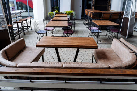 Restaurant on the street, a place of rest for citizens, a lounge area, a wooden table for eating,...