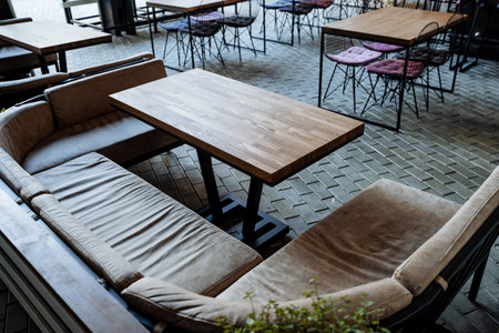 A cozy place for lunch, an outdoor cafe, an empty table, soft seats, sofas for relaxation, a restaurant in the city, an outdoor bar without people. high quality photoの写真素材
