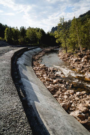 The dam is protective, concrete screed of the river coastline, protection of the roadway from...