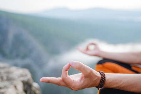 Hands close-up fingers folded into chinmudra, wise for meditation, balance of the inner world, Zen practice in nature, silence of inhalation, bracelet on the arm. high quality photoの写真素材