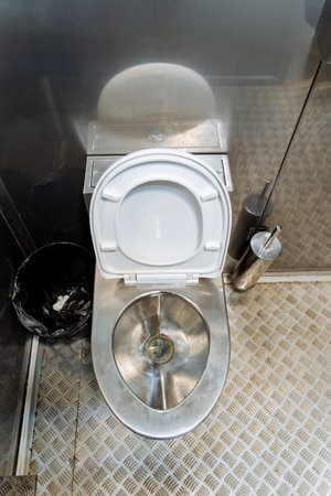 Metal anti-vandal toilet, metal outdoor toilet, sturdy, a latrine in the park, a city toilet, a toilet rim, a garbage can. high quality photoの写真素材