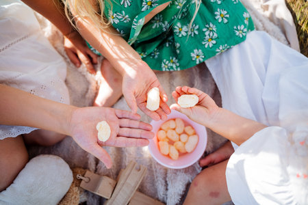 Corn sticks lie in the child's palm, children's hands hold sweets, a summer picnic in nature, a crispy stick. high quality photoの写真素材