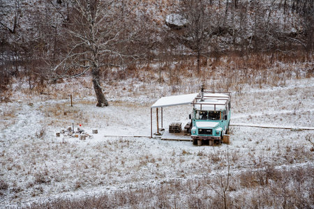 Bus in the forest, tourist camping equipped with old passenger transport, winter recreation center, landscape, top view of the cottage, camping in the forest. High quality photoの写真素材