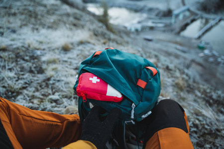 First aid kit sticks out of backpack pocket, camping equipment for survival in the forest, pack backpack for travel. High quality photoの写真素材