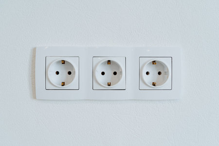 Three sockets in the wall are shot close-up, the power output in the home room. High quality photoの写真素材