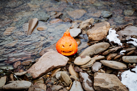 Halloween, a modern international holiday that dates back to the traditions of the ancient Celts of Ireland and Scotland. A pumpkin carved with a knife with evil features. High quality photoの写真素材