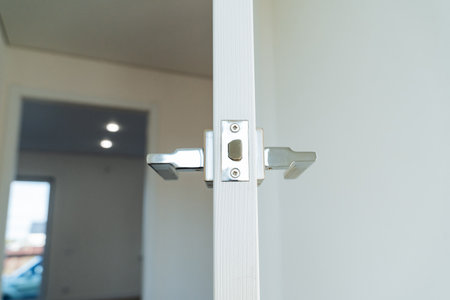 Built-in lock in the door, door handles shot close-up, open door in the room. High quality photoの写真素材