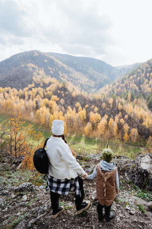 Family vacation in nature, mother and son walking in the mountains, hiking in the autumn forest, school holidays, trekking in the mountains. High quality photoの写真素材