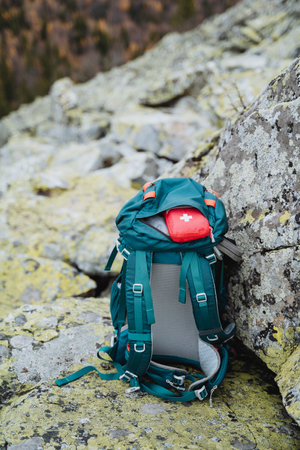A small first aid kit is in the backpack, traveling through the mountains with a backpack, trekking...