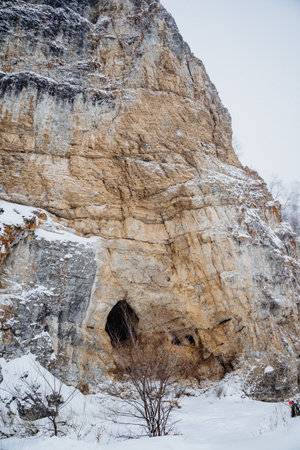 Kalimuskan Rock and Salavat Cave in Bashkiria, entrance to the cave in the mountain, winter landscape, nature of Russia. High quality photoの写真素材