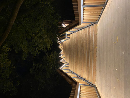 Wooden staircase with LED lighting, pedestrian staircase in park, urban infrastructure at night, illuminated pedestrian path. High quality photoの写真素材