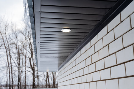 Street lighting, spot lighting on the roof of the house, country house, roof gable. High quality...