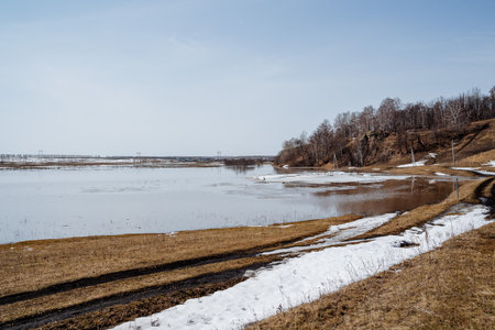 Spring in nature, flooding on the river, flooded crop fields, snow melting, the river overflowing its banks, natural disaster. High quality photoの写真素材