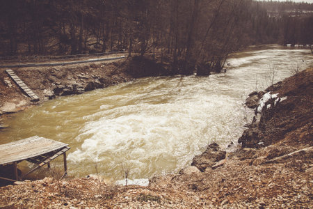 Wooden dock on river landscape with trees and waterの写真素材