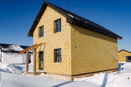 Country house facade insulation with mineral wool, eco-friendly insulation material, house construction, winter, roofless porch. High quality photoの写真素材
