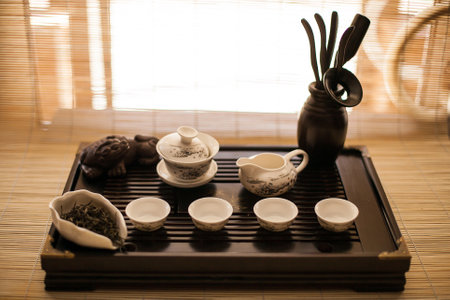 A wooden tray showcasing a tea set, perfect for serving tea and snacks. This elegant display adds a touch of warmth and charm to any kitchen or dining roomの写真素材