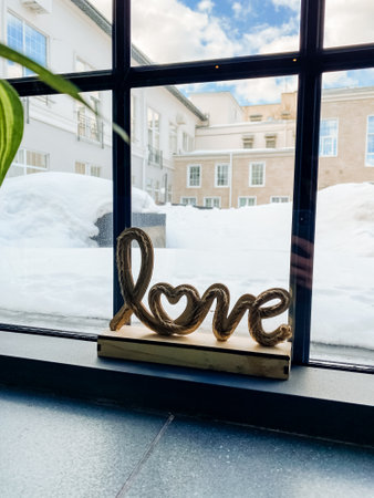 An artistic fixture in the form of a rectangular window with a love sign displayed in a stylish...