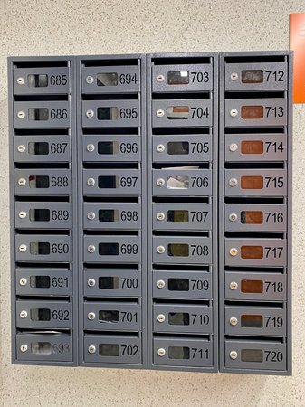 a row of mailboxes with numbers on them on a wall
