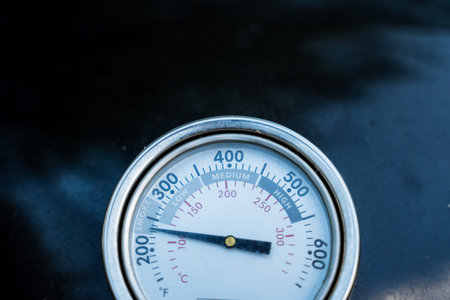 An electric blue thermometer displays a temperature of 400 degrees Fahrenheit. This device is used to measure temperature accurately and is an essential tool for monitoring changes in heat levelsの写真素材