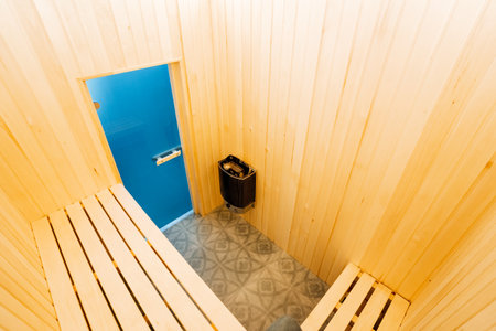 Immerse yourself in the peaceful environment of a tranquil sauna, complete with a serene blue door and inviting wooden benches. Its the perfect place to relax and unwind after a long dayの写真素材